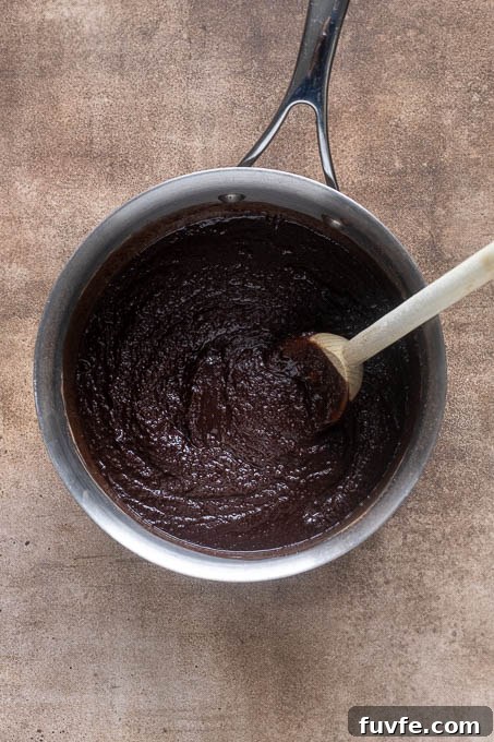 Melted butter with sugar and cocoa powder for cocoa brownies.