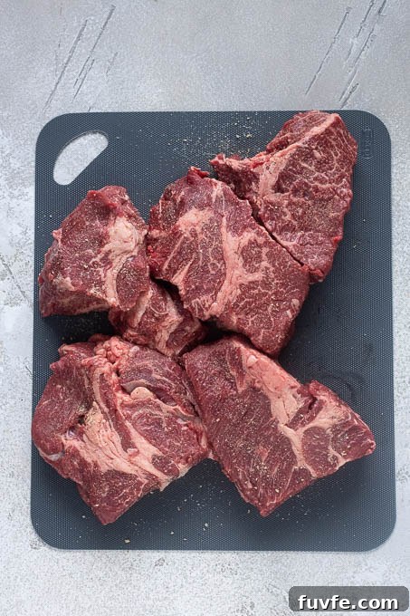 Seasoned beef chuck roast cut into large chunks.