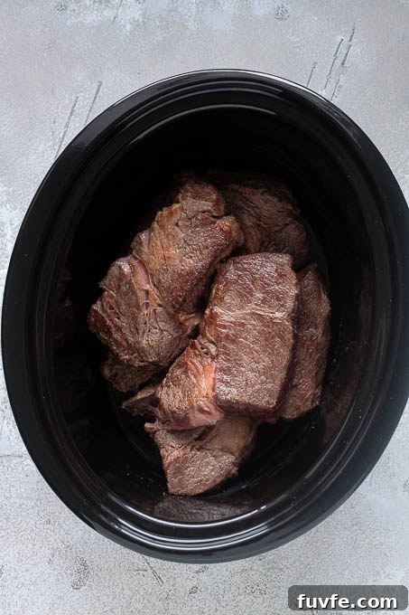 Browned beef chuck roast in the slow cooker.