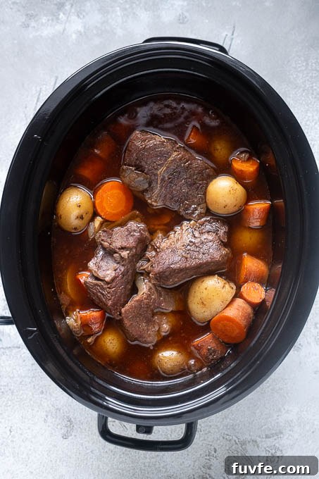 Pot roast in slow cooker after cooking.