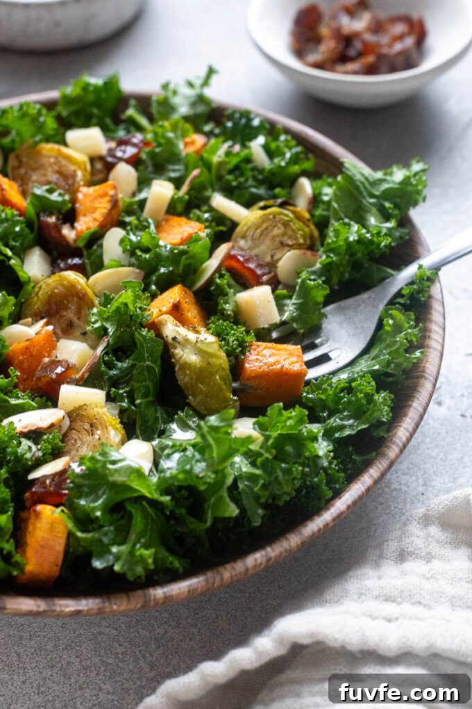 Roasted Winter Vegetables and Kale Salad 10 Winter kale salad with sweet potatoes and brussels sprouts in a bowl.