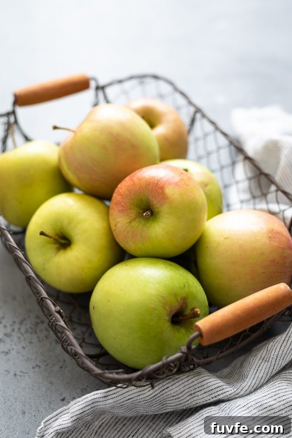 close up of apples in a wire basket