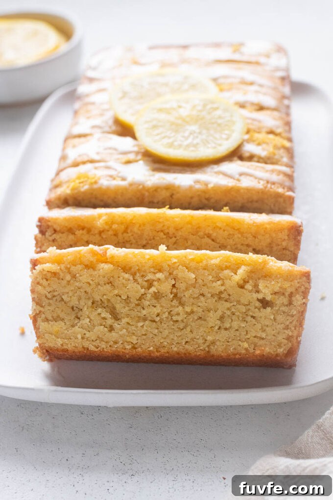 Lemon loaf with almond flour sliced on a platter.