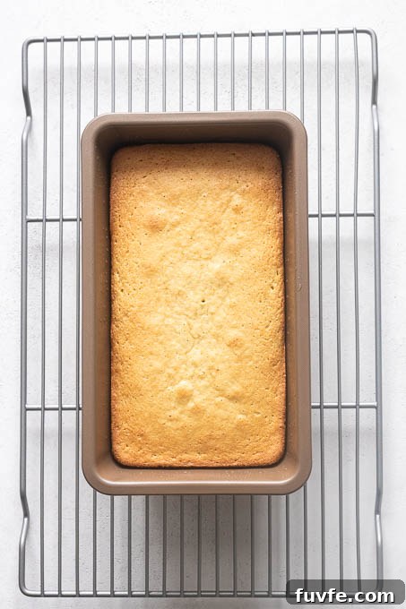 Baked almond flour lemon loaf cake on wire rack.