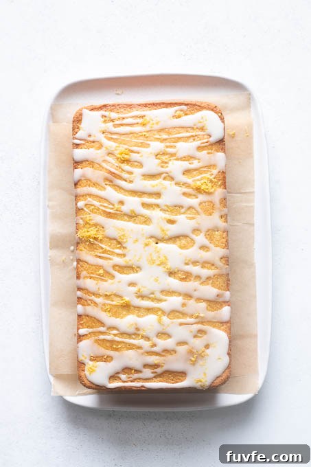 Lemon glaze drizzled over gluten-free lemon loaf.