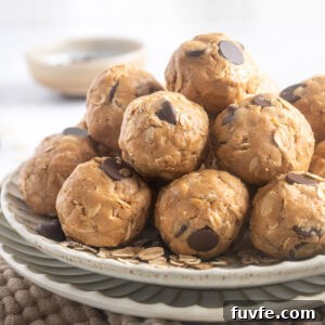 No-Bake Peanut Butter Protein Balls Recipe 10 Peanut Butter Protein Balls piled on a plate.