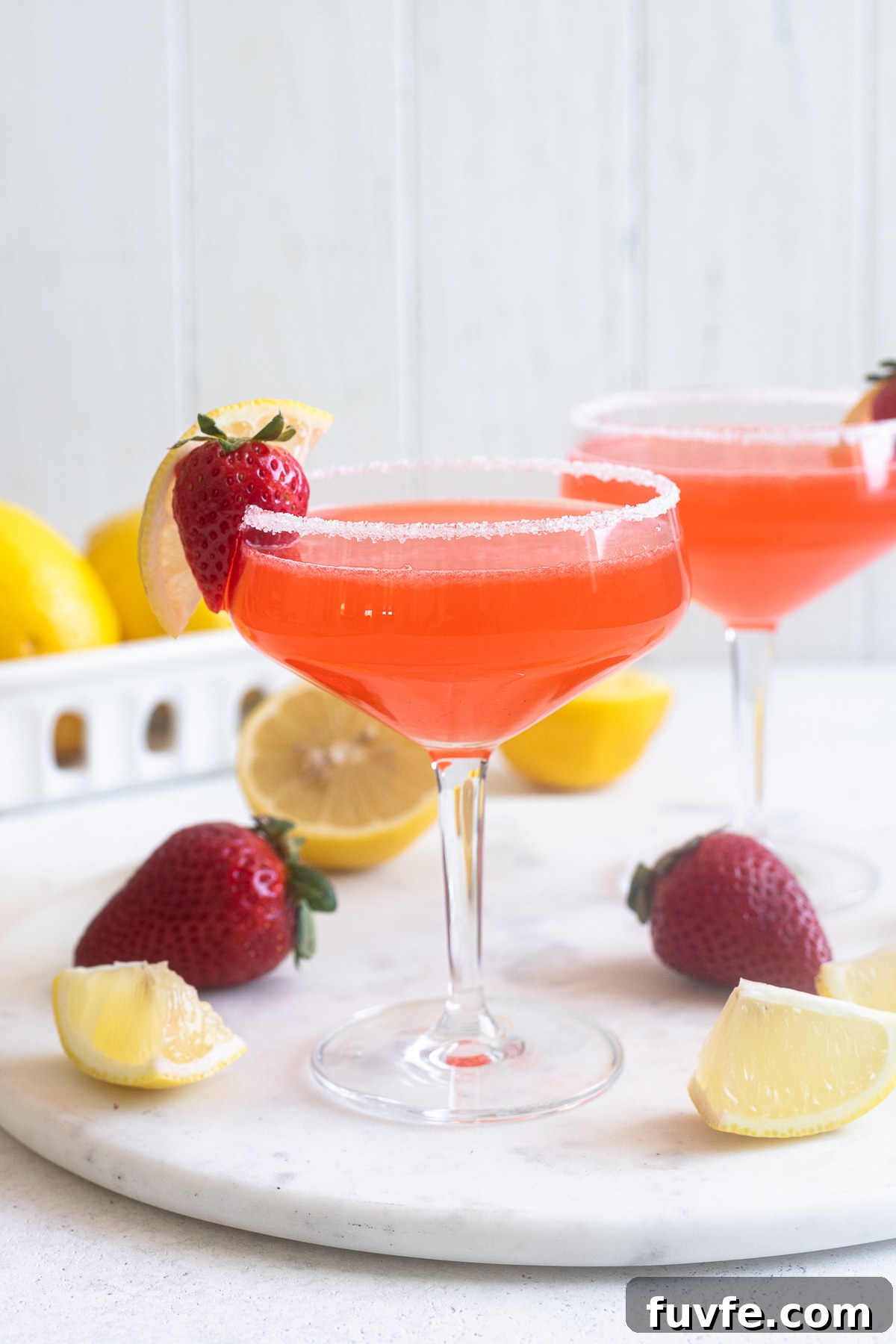 Fresh strawberry lemon drop martini in coupe glass.