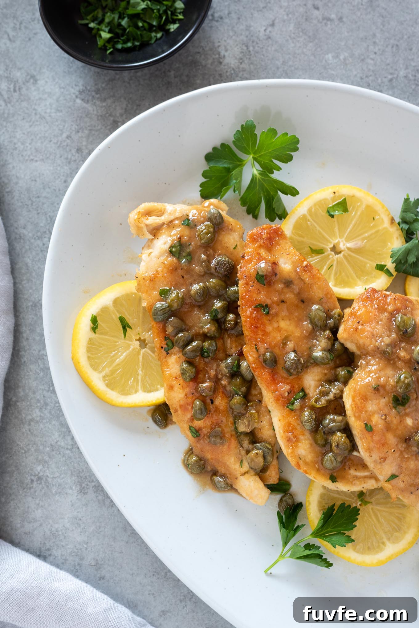 Chicken piccata on a serving plate