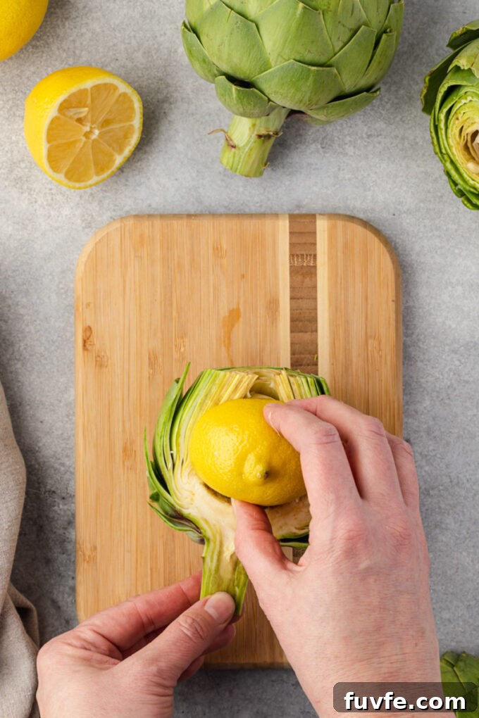 How to Trim and Prepare an Artichoke for Cooking 7 Rubbing lemon on cut artichoke to prevent browning.