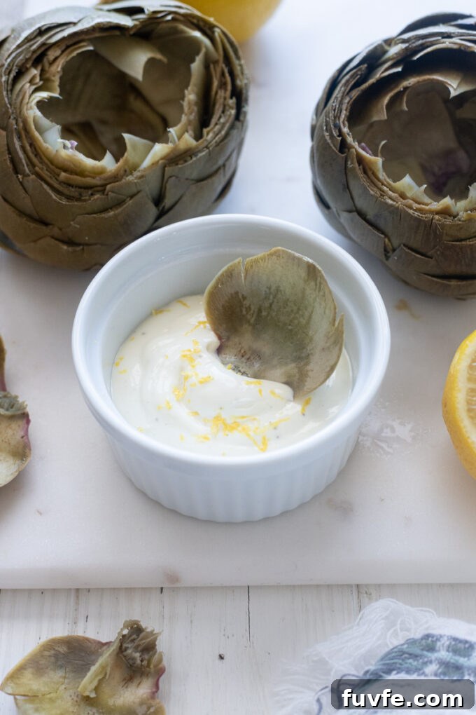 How to Cook Tender Instant Pot Artichokes 15 Artichoke leaf dunked in lemon garlic aioli.