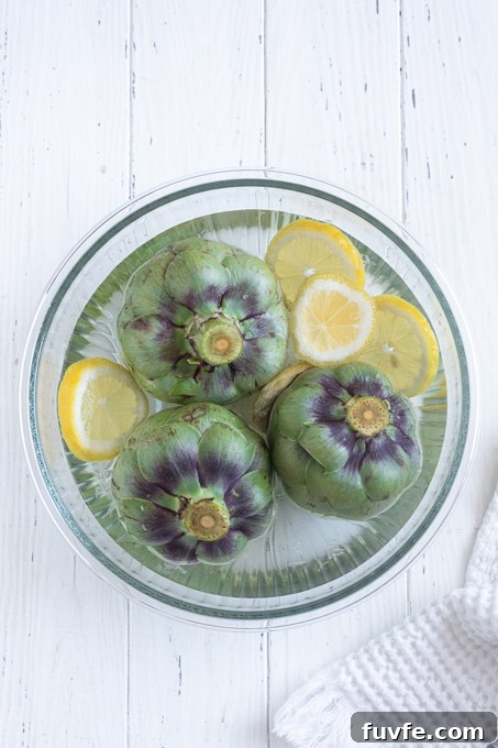 How to Cook Tender Instant Pot Artichokes 7 Prepped artichokes in lemon water for instant pot artichokes.