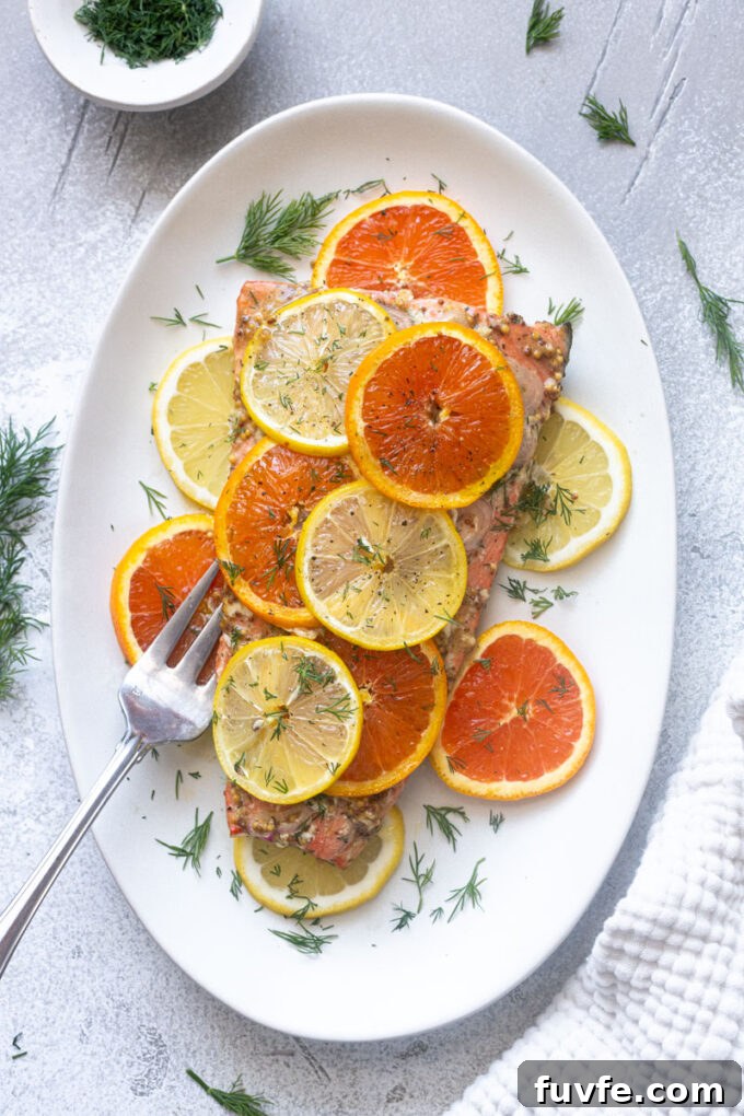 Overhead view of baked citrus salmon with Dijon, lemon and orange.