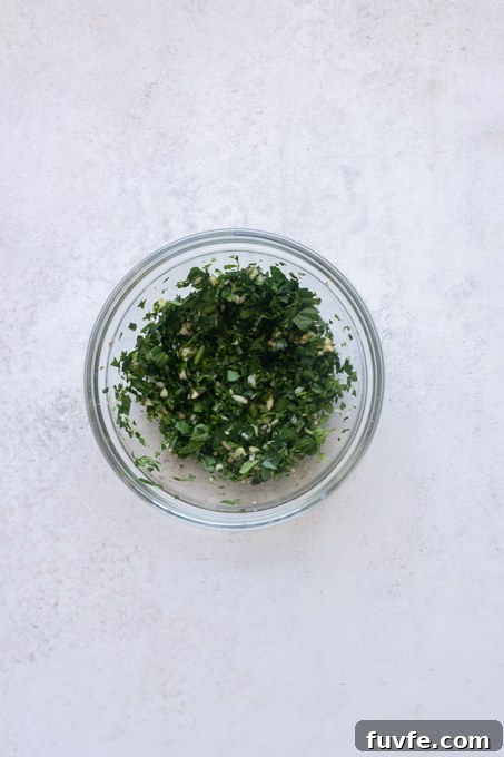 Carciofi alla Romana: Roman-Style Artichoke Recipe 10 Minced garlic and chopped fresh parsley and mint in a small bowl.