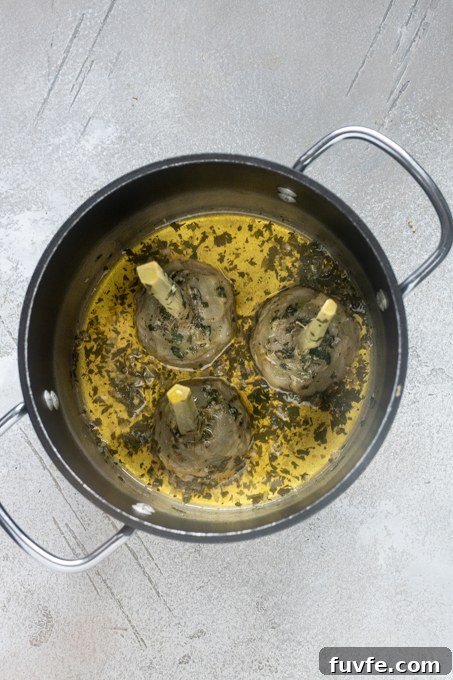 Cooked Roman artichokes in pot.