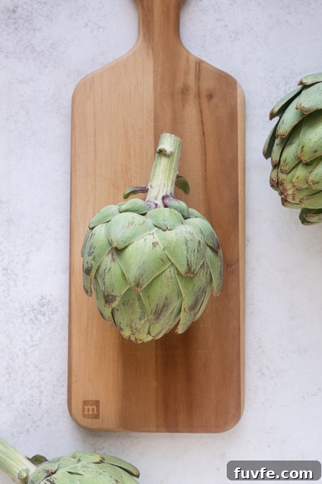 Remove the top of the artichoke stem.