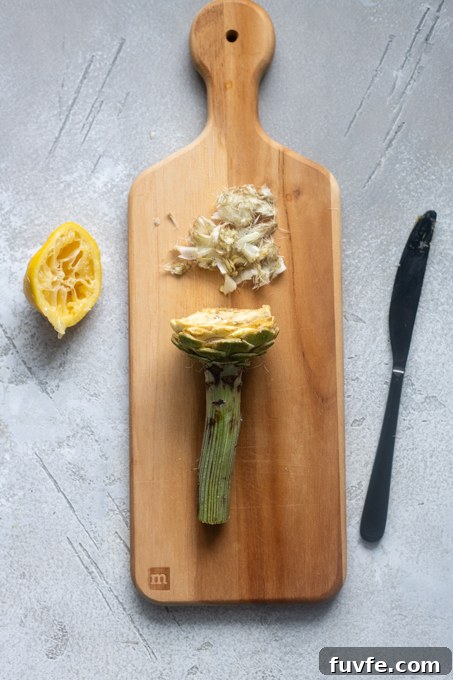 Carciofi alla Romana: Roman-Style Artichoke Recipe 7 Pale yellow leaves cut off of artichoke and fuzzy choke removed.