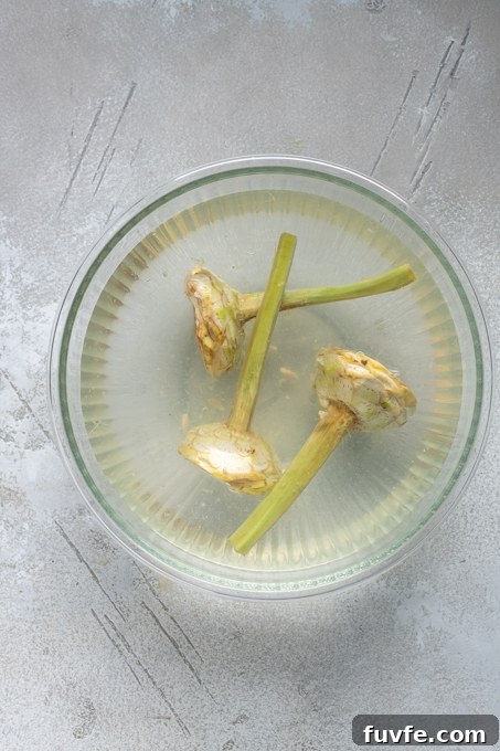 Carciofi alla Romana: Roman-Style Artichoke Recipe 9 Prepped Roman artichokes in lemon water.