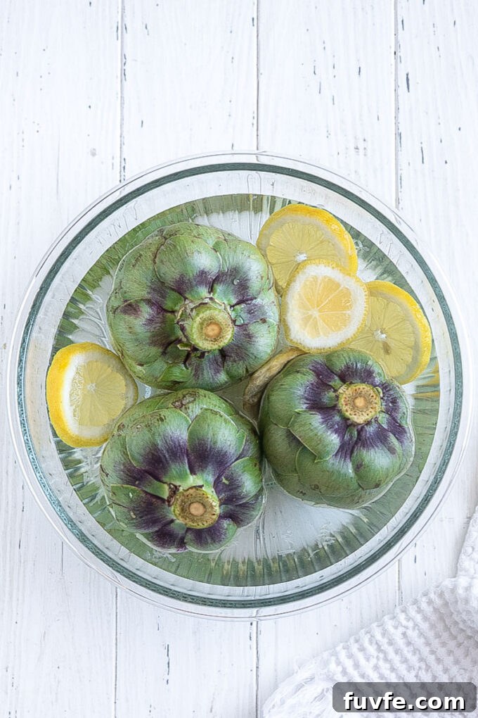 Prepped fresh artichokes in lemon water.