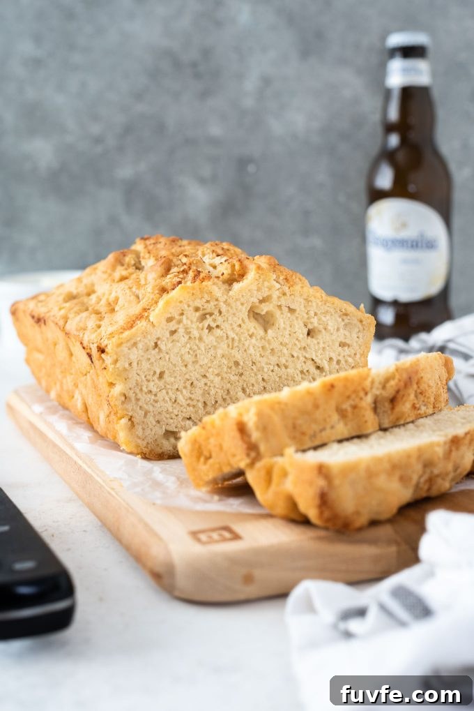 Loaf of beer bread sliced on a cutting board