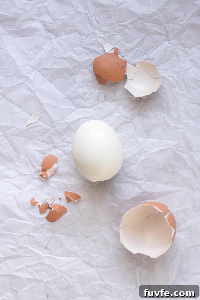 Peeled air fryer hard boiled eggs with large pieces of shell.
