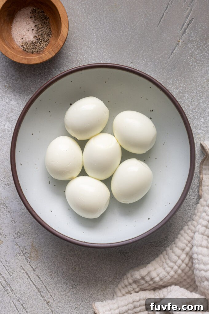 Peeled air fryer hard boiled eggs in a bowl.