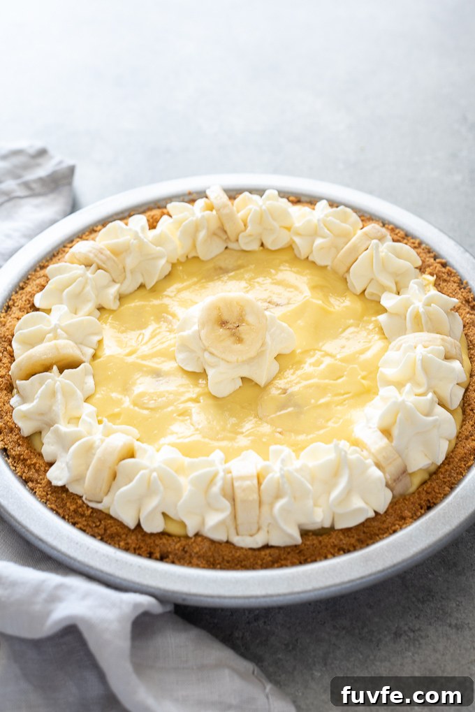 Banana Cream Pie Recipe with Graham Cracker Crust 3 Banana cream pie with a linen alongside