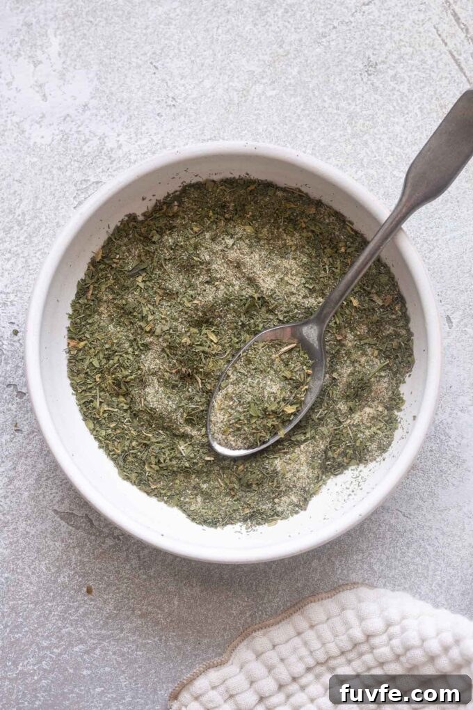 How to Make Homemade Ranch Seasoning Mix 3 Overhead shot of ranch seasoning in bowl with spoon.