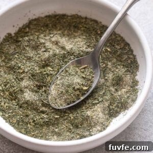 Homemade ranch seasoning in a bowl with spoon.