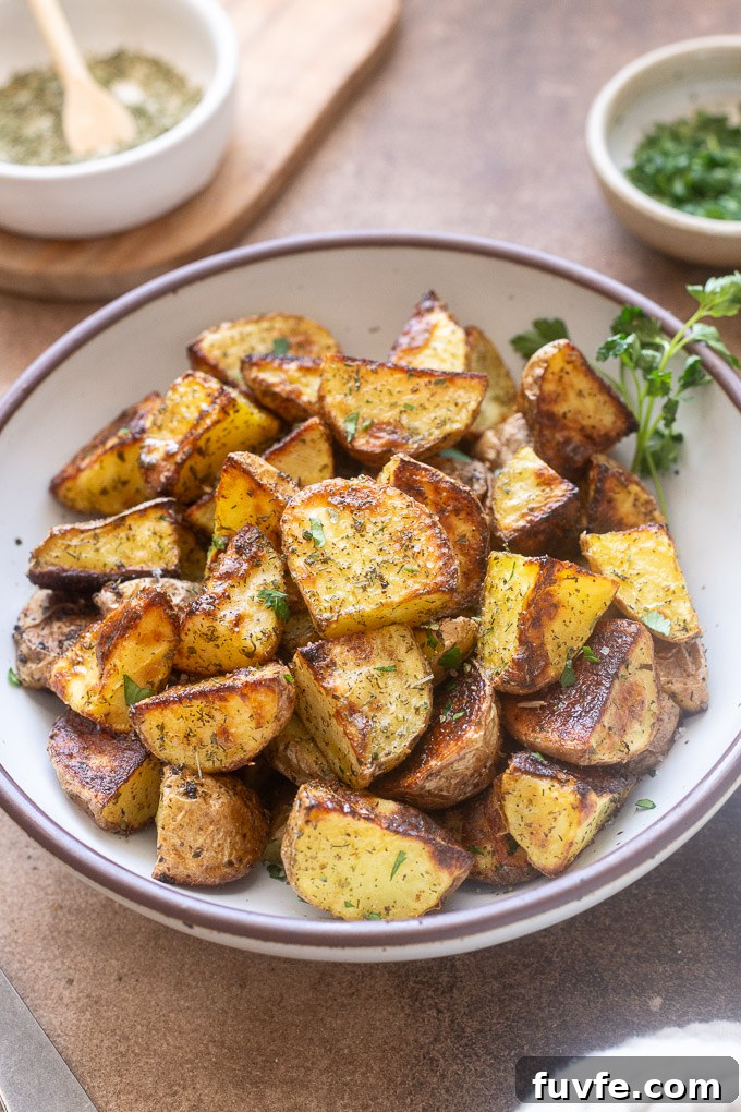 Crispy Ranch Roasted Potatoes Recipe 2 Ranch potatoes in a bowl garnished with parsley.