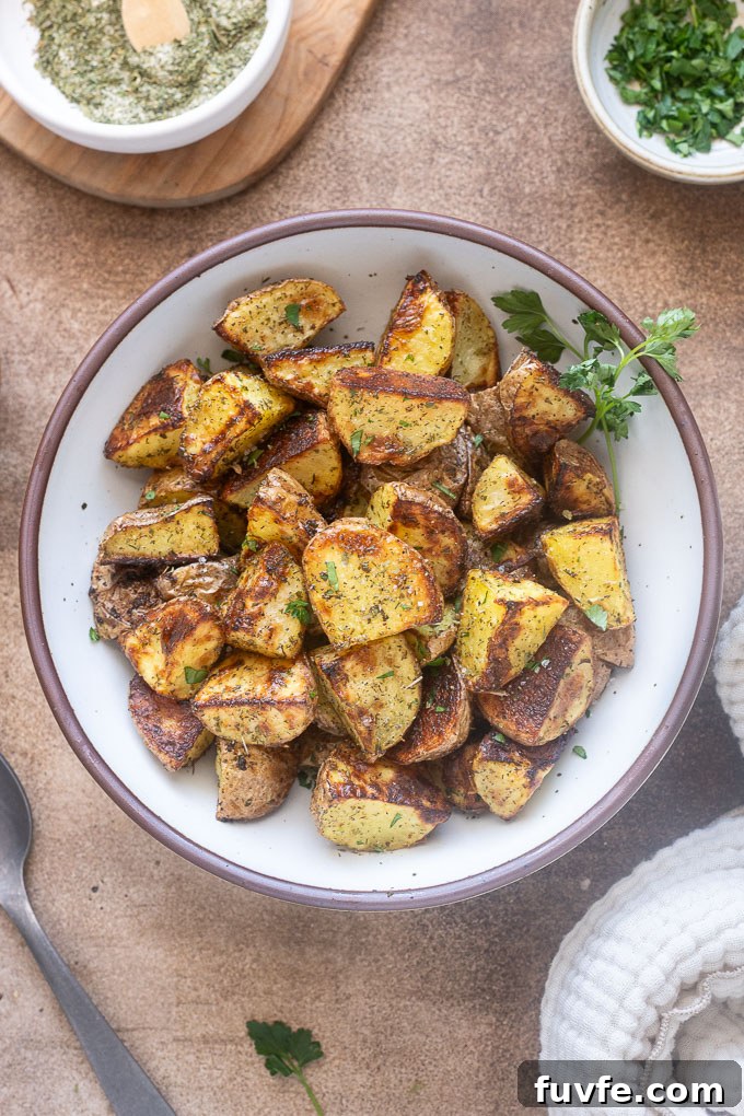 Crispy Ranch Roasted Potatoes Recipe 3 Ranch roasted potatoes in a bowl with parsley sprigs.