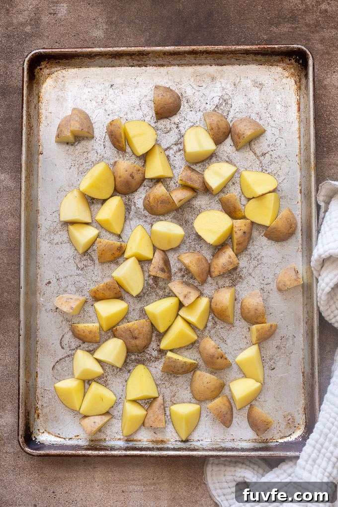 Crispy Ranch Roasted Potatoes Recipe 6 Quartered baby gold potatoes in a single layer on a baking sheet.