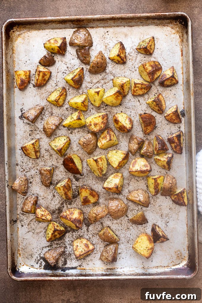 Crispy Ranch Roasted Potatoes Recipe 8 Crispy ranch roasted potatoes on a baking sheet.