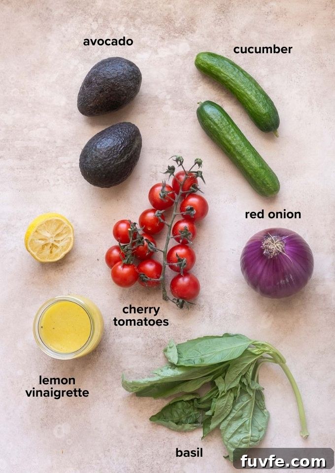 ingredients for cucumber tomato avocado salad with basil and lemon vinaigrette.