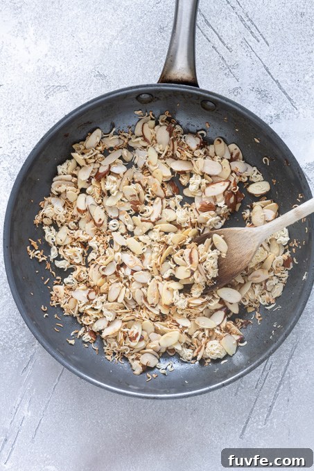 Toasted ramen noodles and almonds in a skillet.