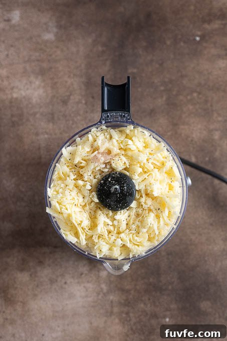 Pub cheese recipe ingredients in a food processor before processing.