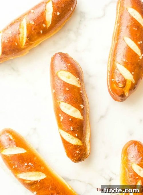 Soft pretzel hot dog buns on marble board
