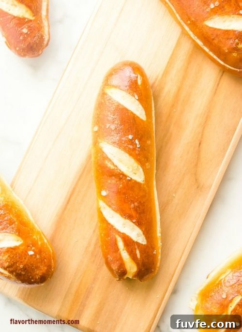 Soft pretzel hot dog buns on cutting board
