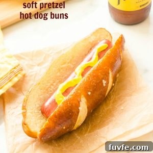 Hot dog in homemade soft pretzel hot dog bun with mustard.