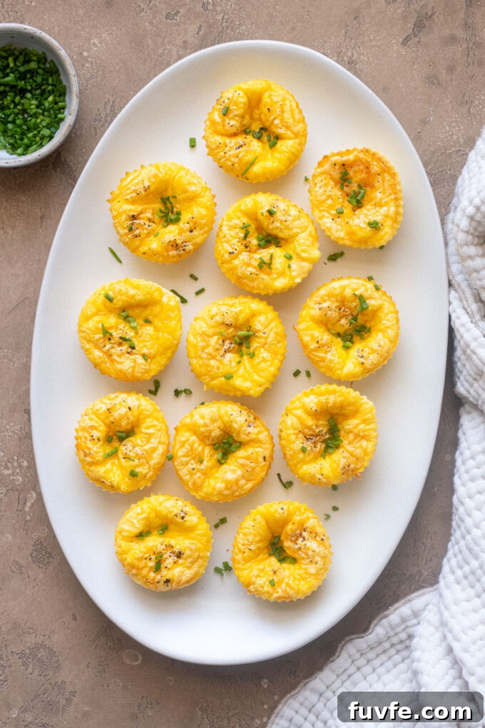 Cottage cheese egg bites on a platter topped with chives.