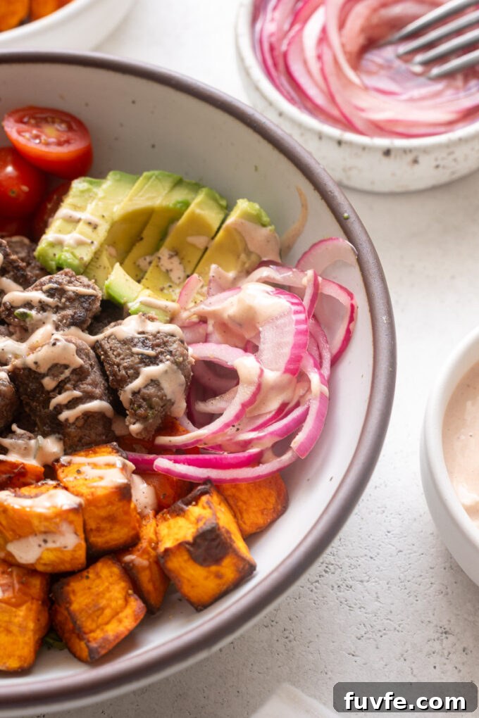 Pickled red onions in a burger bowl.