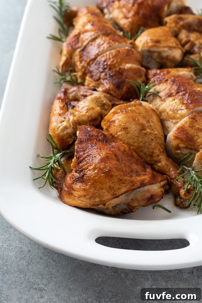 Carved spatchcock chicken on platter with rosemary