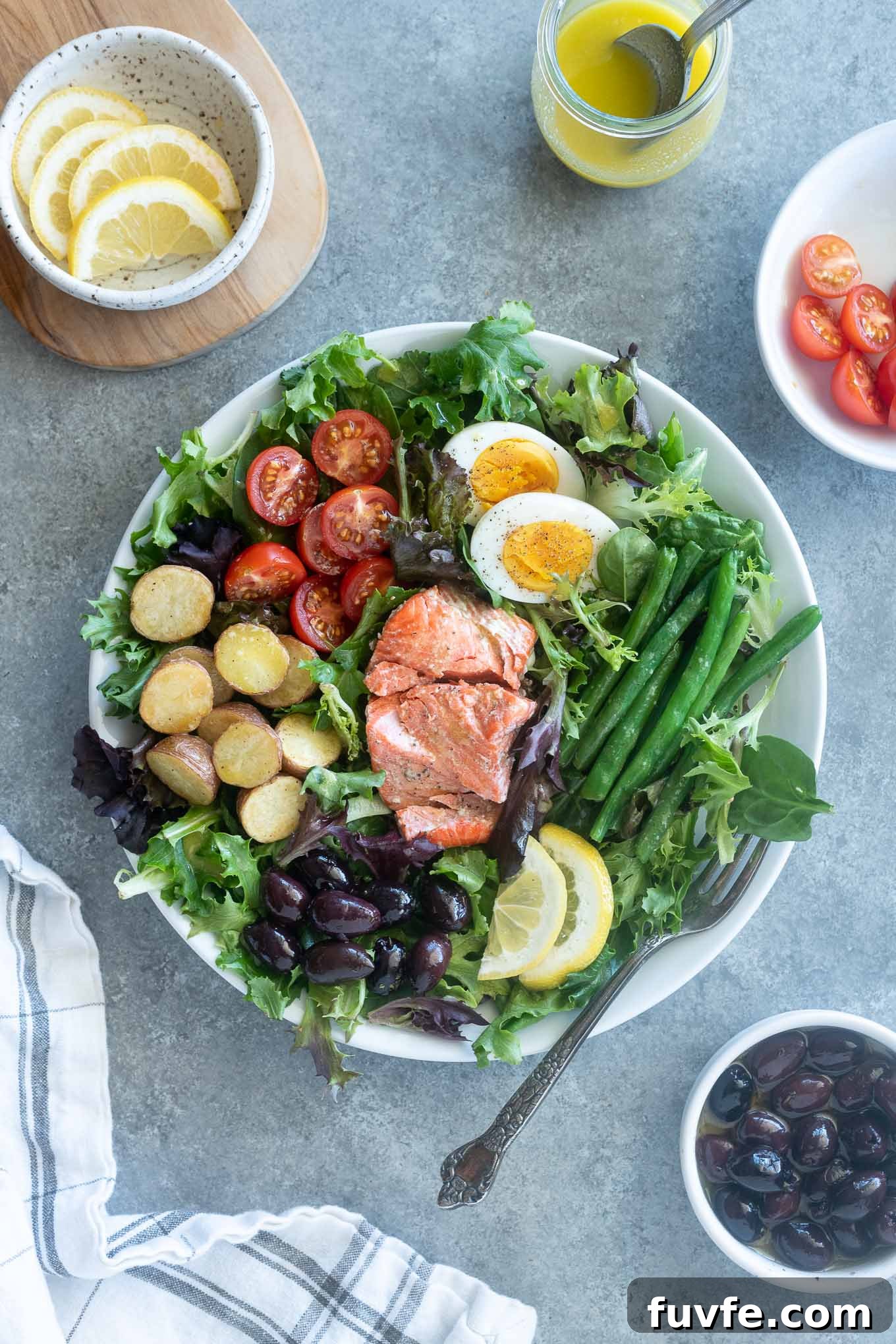 15+ High-Protein Salad Recipes for Filling Lunches and Dinners 9 Salmon nicoise salad with ingredients surrounding