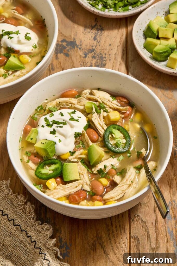 Slow Cooker Chicken Enchilada Verde Soup 3 Bowl of green enchilada chicken soup with sour cream, avocado and jalapenos.