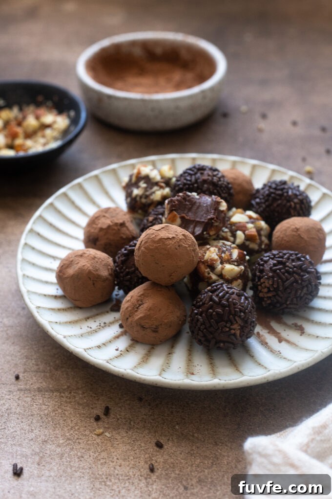 Caramel truffles piled on a white plate.