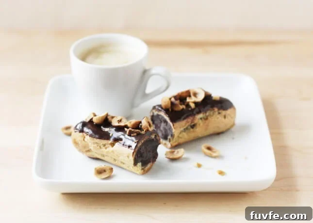 A chocolate éclair topped with toasted hazelnuts // FoodNouveau.com