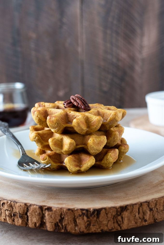 Stack of sweet potato waffles on a white plate