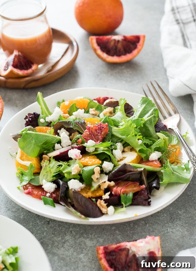 Roasted Beet and Goat Cheese Salad 3 Roasted beet salad on a plate with blood orange dressing in background