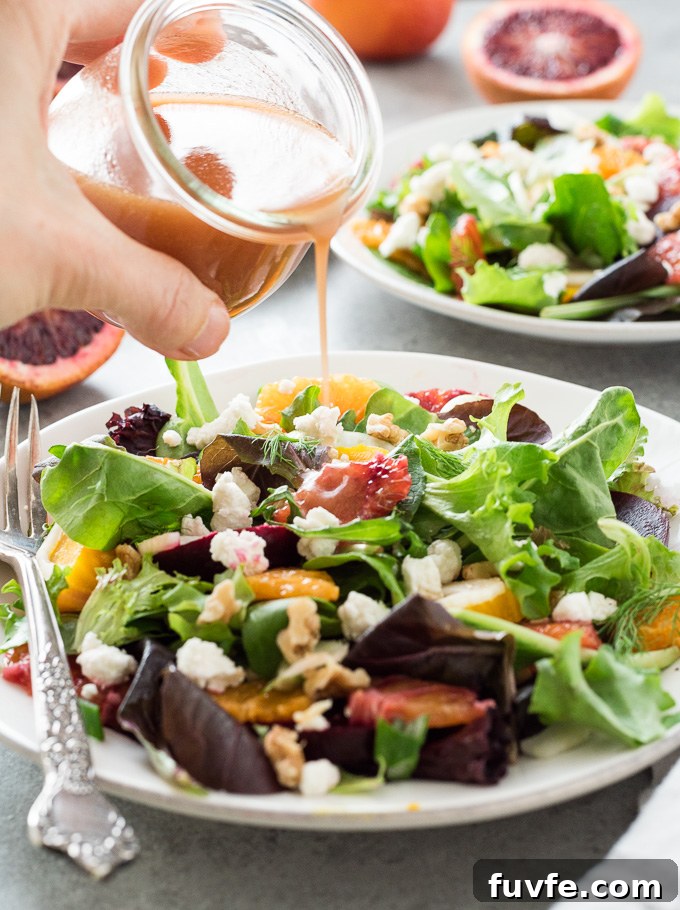 Roasted Beet and Goat Cheese Salad 9 Blood orange dressing pouring over roasted beet salad