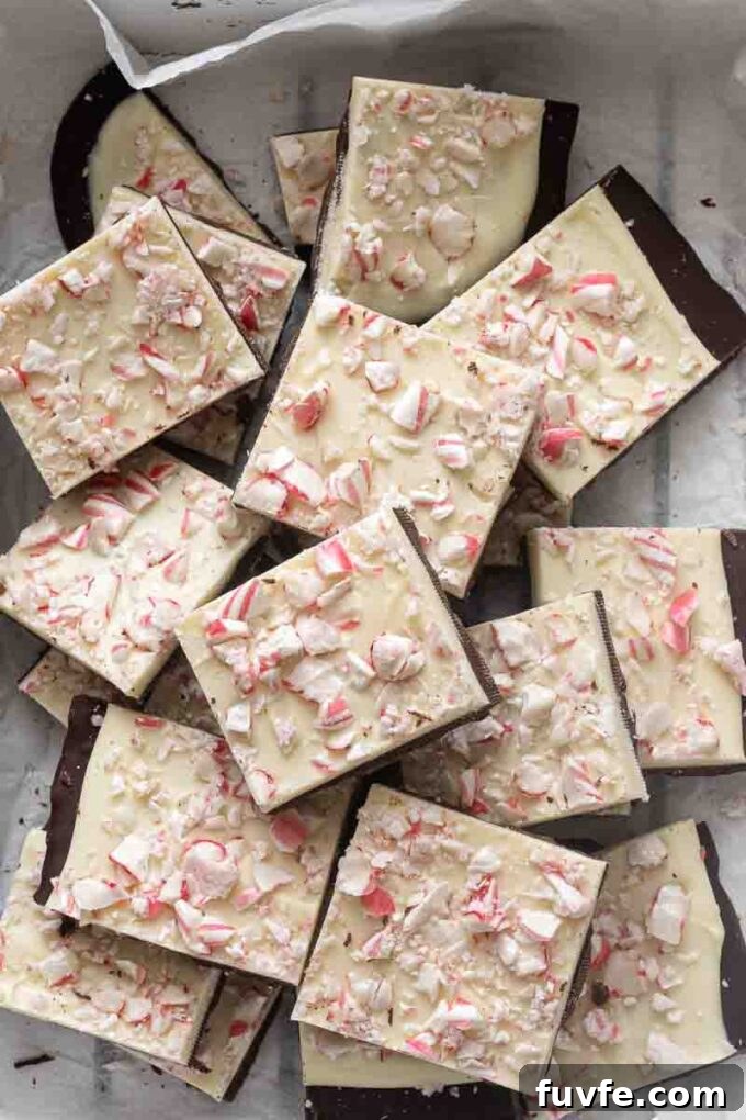 Squares of peppermint bark with layers of dark chocolate, white chocolate and peppermint.