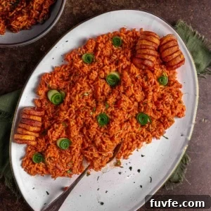 Smoky Nigerian Jollof Rice Recipe – Authentic West African Flavor 12 Nigerian jollof rice served on a platter with fried plantains.
